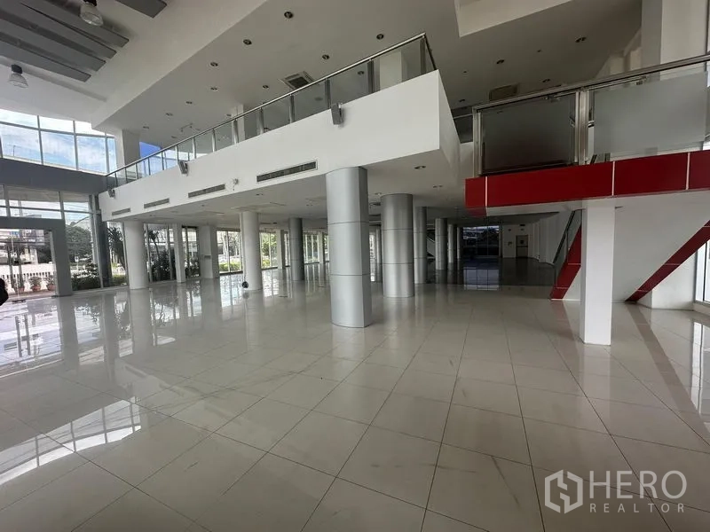 Retail Space for rent in Prawet, Bangkok - Modern retail hall with mezzanine level, stainless railings, and wide open spaces.