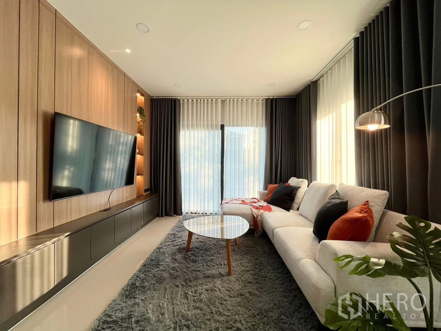 Detached House for rent in Bang Phli, Samut Prakan - Living area from another angle showing built-in wall unit and big windows.
