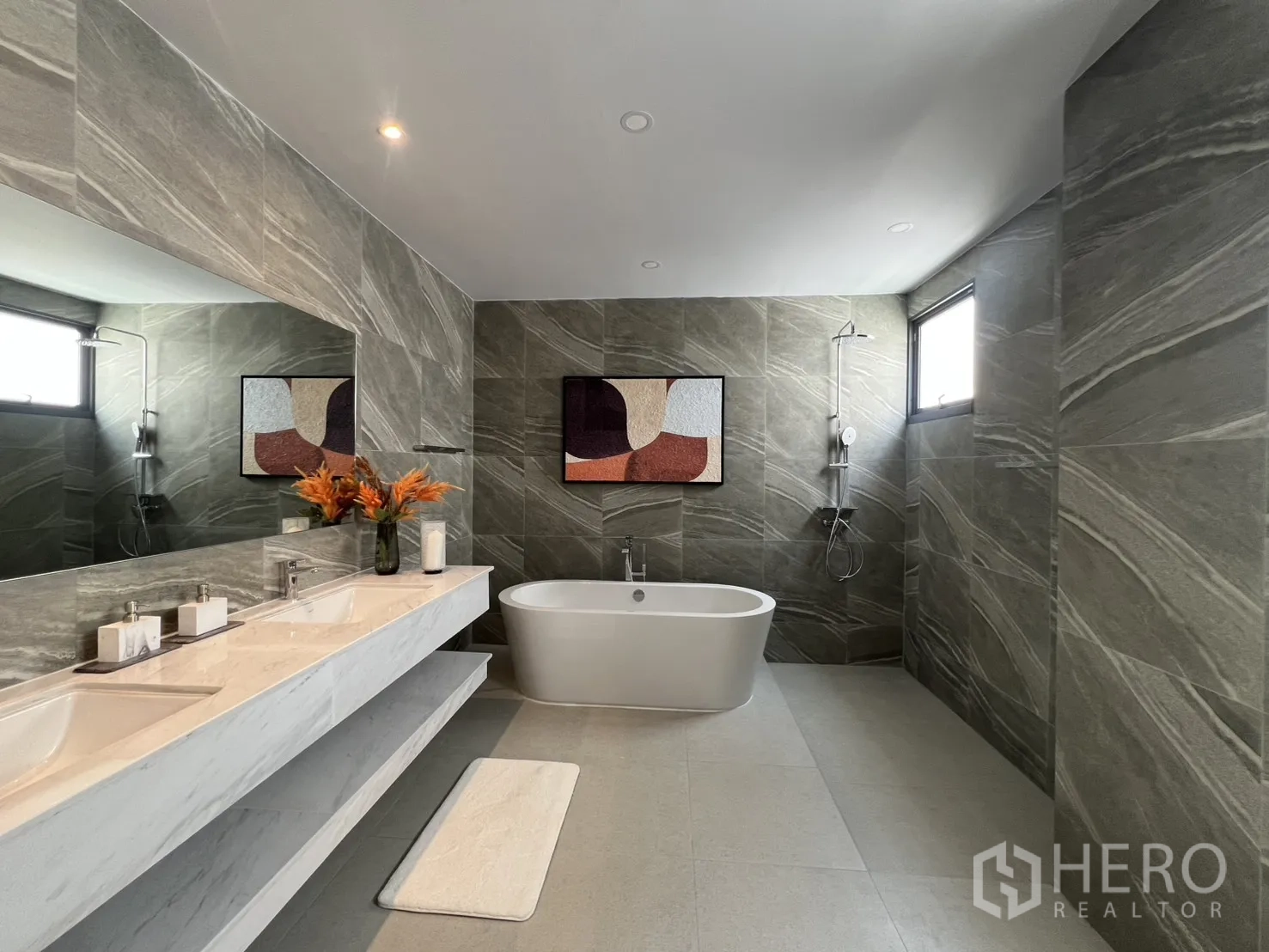 Townhouse for rent in Mueang Samut Prakan, Samut Prakan - Luxury bathroom featuring freestanding bathtub, double vanity, and stone-effect walls.