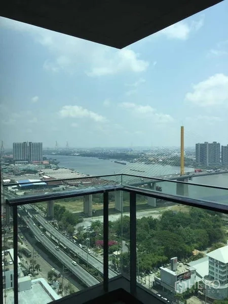 Condominium for sale - Glass-balustrade balcony with daytime panoramic river and city views.