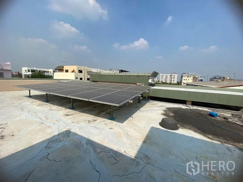 Home Office for rent in Don Mueang, Bangkok - Rooftop solar panel array on a flat roof with city views.