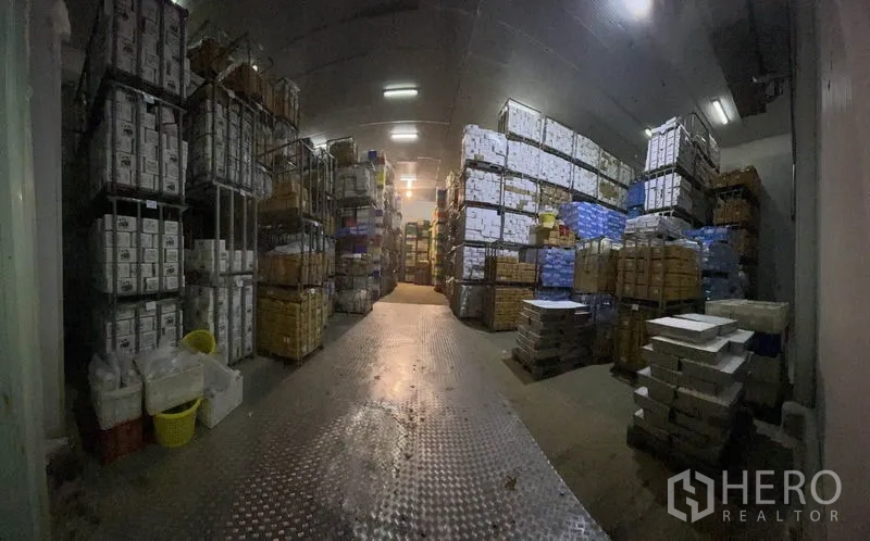 工厂 出售在Mueang Samut Sakhon, Samut Sakhon - 冷库仓储区，纸箱整托堆放于金属货架上，顶部为保温天花。