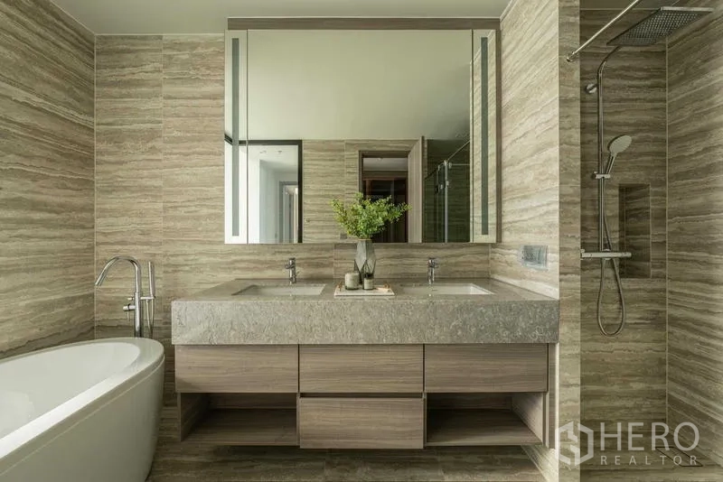 Condominium for rent - Spacious bathroom with double vanity, rain shower and freestanding bathtub in stone finishes.