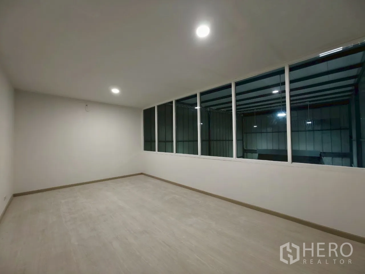 Warehouse for rent in Phra Khanong, Bangkok - Office with large internal windows looking over the warehouse space.