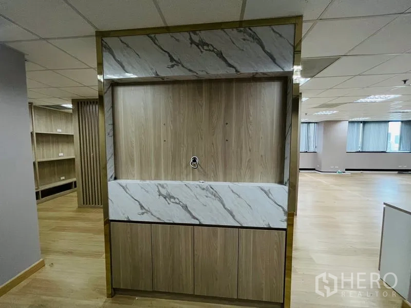 Office Space for rent - Pantry or reception niche finished with marble-look and wood cabinetry.