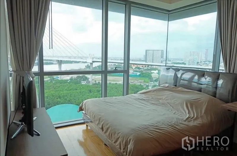 Condominium for rent or sale in Yan Nawa, Bangkok - Corner bedroom with wraparound windows and river outlook.