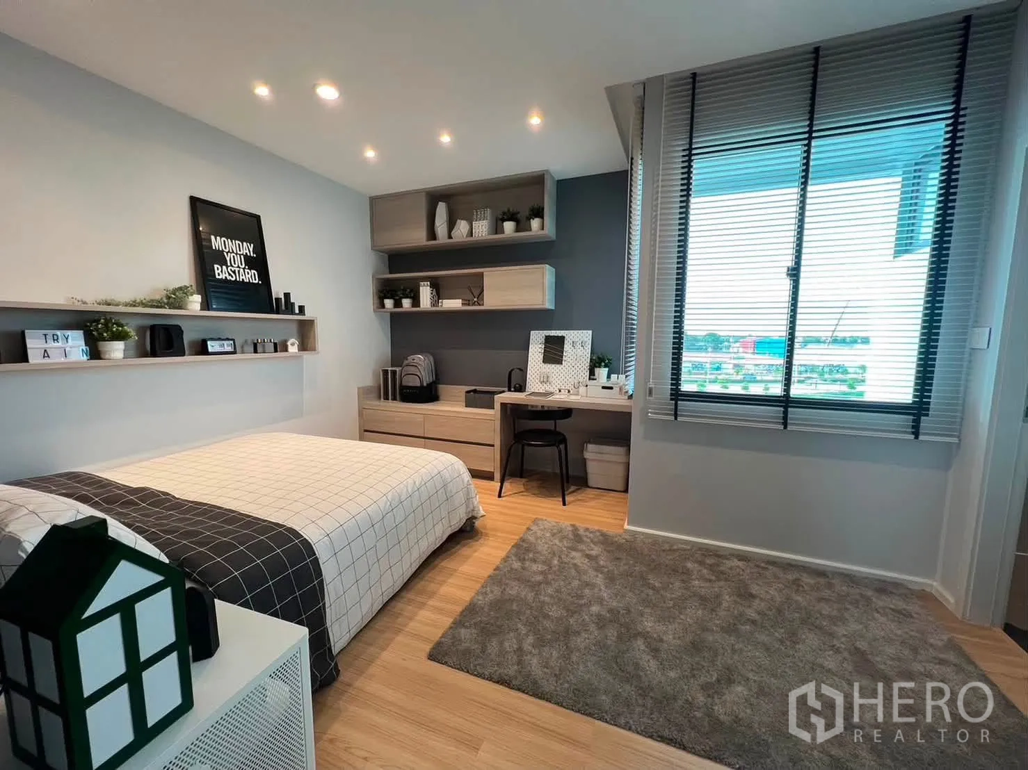 Townhouse for rent in Saphan Sung, Bangkok - Bright bedroom with bed, study desk, shelves, and large window with blinds.