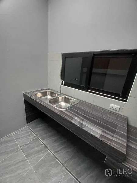 零售空间 出租在Khlong Toei, Bangkok - 茶水间，双不锈钢水槽与石纹台面，旁有推拉窗