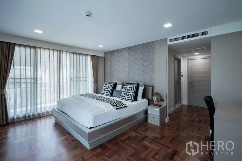 Apartment for rent - Large master bedroom with floor-to-ceiling windows and ensuite access.