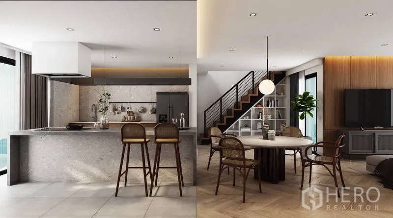 Detached House for rent in Watthana, Bangkok - Stone island kitchen with bar stools adjoining the dining area and staircase with metal railing.