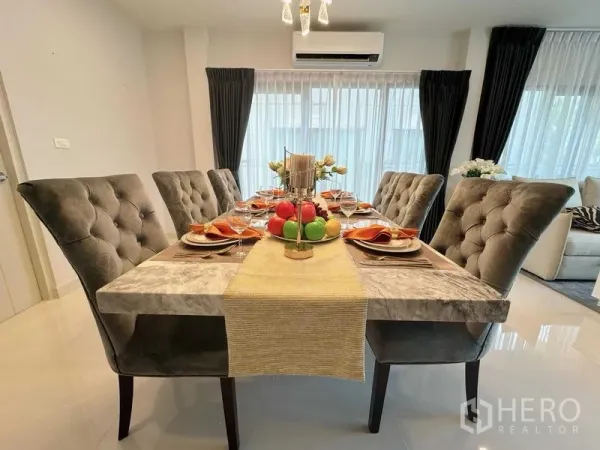 Detached House for rent or sale - Elegant dining room featuring a marble table set for eight, tufted chairs and pendant lighting.