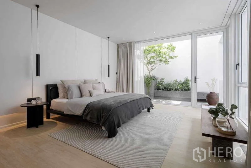 Home Office for rent in Bang Phli, Samut Prakan - Primary bedroom with floor-to-ceiling glass opening to a private terrace planter.