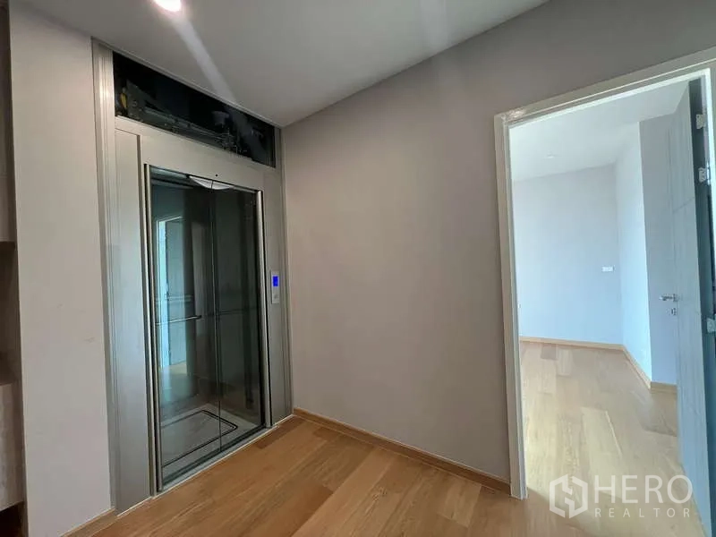 Detached House for sale in Suan Luang, Bangkok - Home elevator at the upper-floor landing with wood flooring
