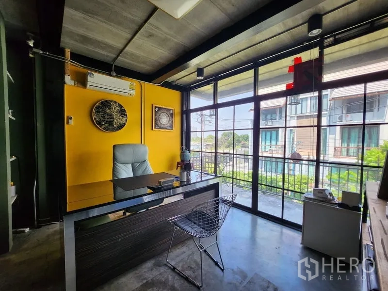 Home Office for sale - Private executive office with yellow accent wall and full-height windows to a balcony view.