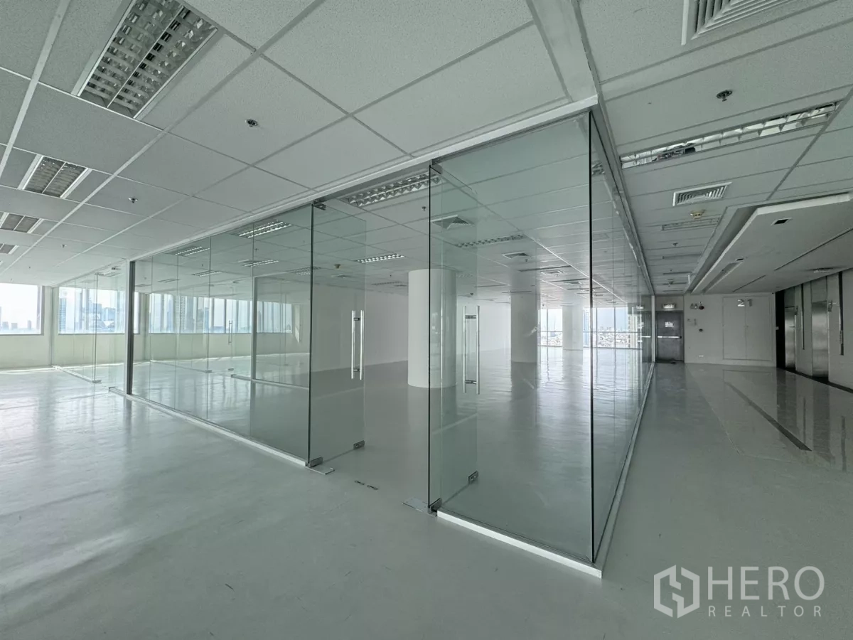 Office Space for rent in Sathon, Bangkok - Bright open-plan office with glass-partitioned meeting rooms, grid ceiling lighting and city views near BTS Saint Louis in Sathon, Bangkok.