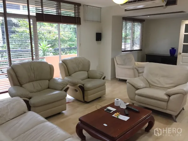 Detached House for rent in Watthana, Bangkok - Upper lounge with cream leather sofas, wood flooring and wide windows.