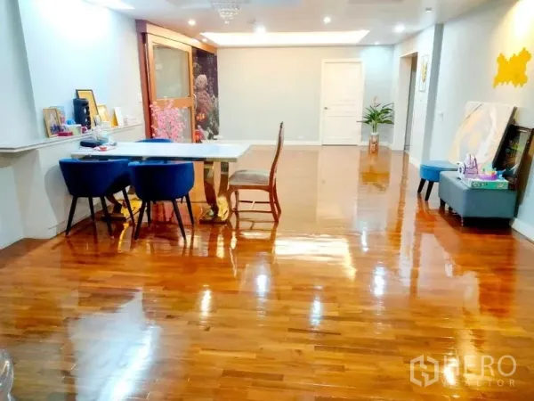 Condominium for rent in Khlong Toei, Bangkok - Alternate angle of the expansive living space showcasing gleaming hardwood floors.