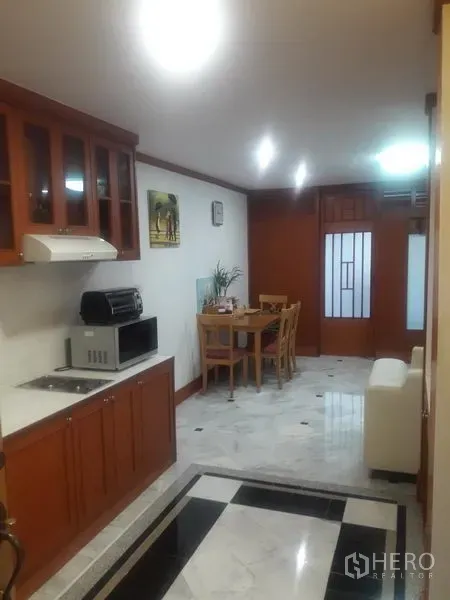 คอนโด ให้เช่าในWatthana, Bangkok - ครัวเปิดโล่งตู้ไม้ เตา เครื่องดูดควัน พร้อมโต๊ะทานอาหาร พื้นหินอ่อน