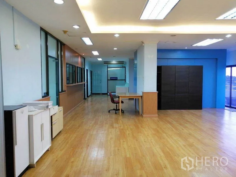 Office Space for rent in Bueng Kum, Bangkok - Open‑plan workspace with blue accent wall, desks, and ceiling lighting.