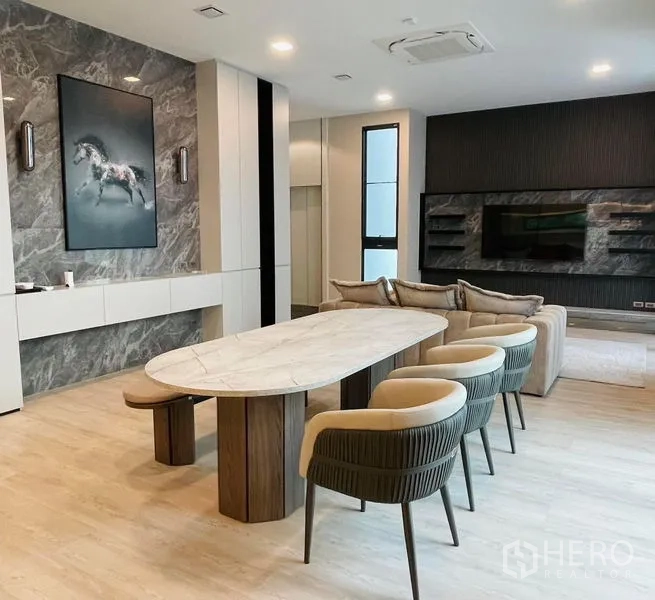 独立式住宅 出租 - 餐厅配椭圆大理石餐桌与软包餐椅，旁为媒体墙。