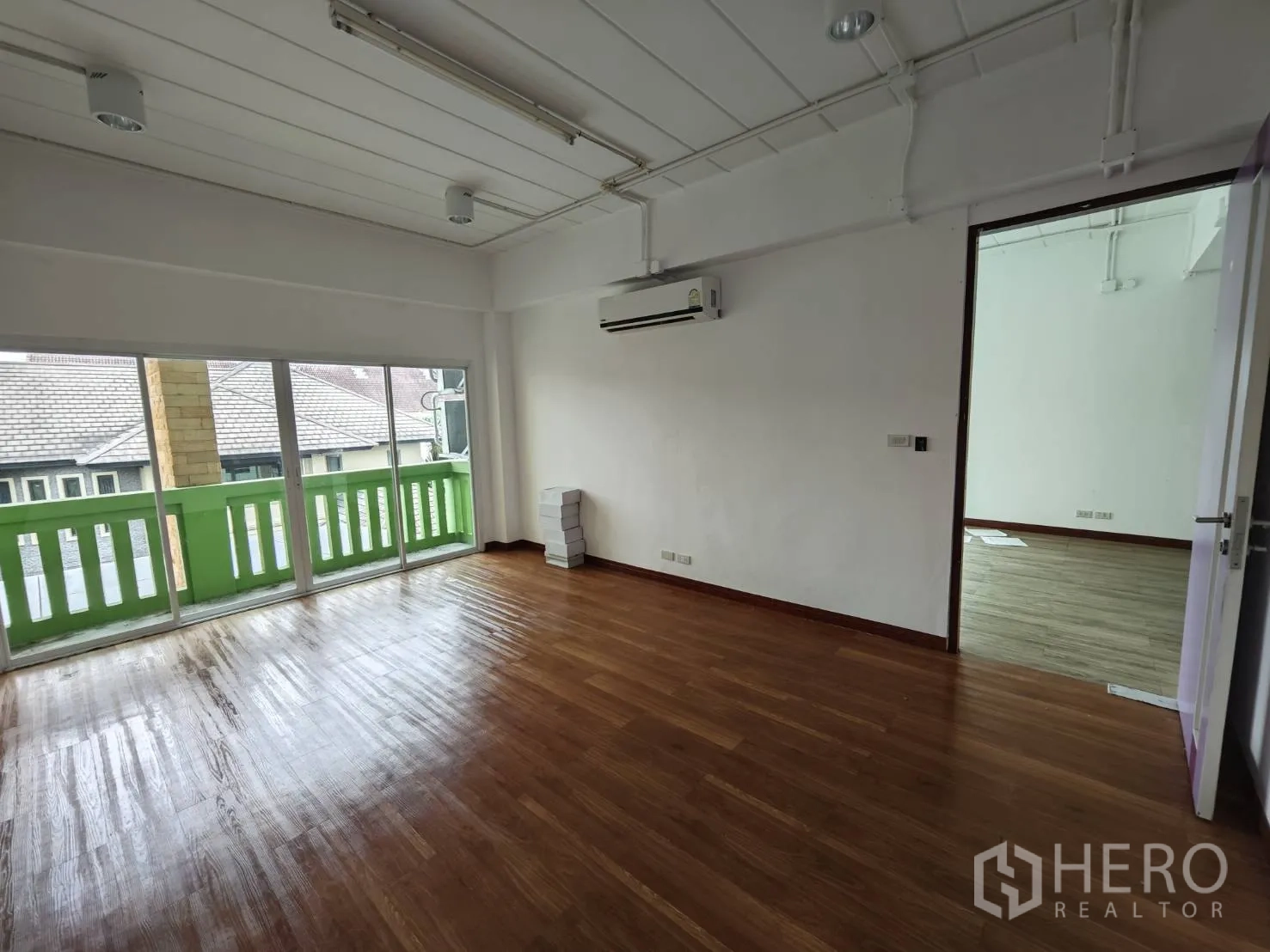 Office Space for rent in Prawet, Bangkok - Office room opening to a small balcony with sliding glass doors and air conditioning.