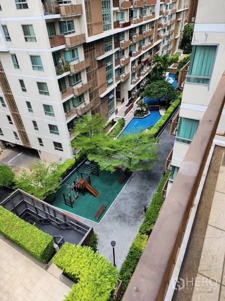 公寓 出租在Watthana, Bangkok - 阳台俯瞰游泳池、儿童游乐场与景观庭院。