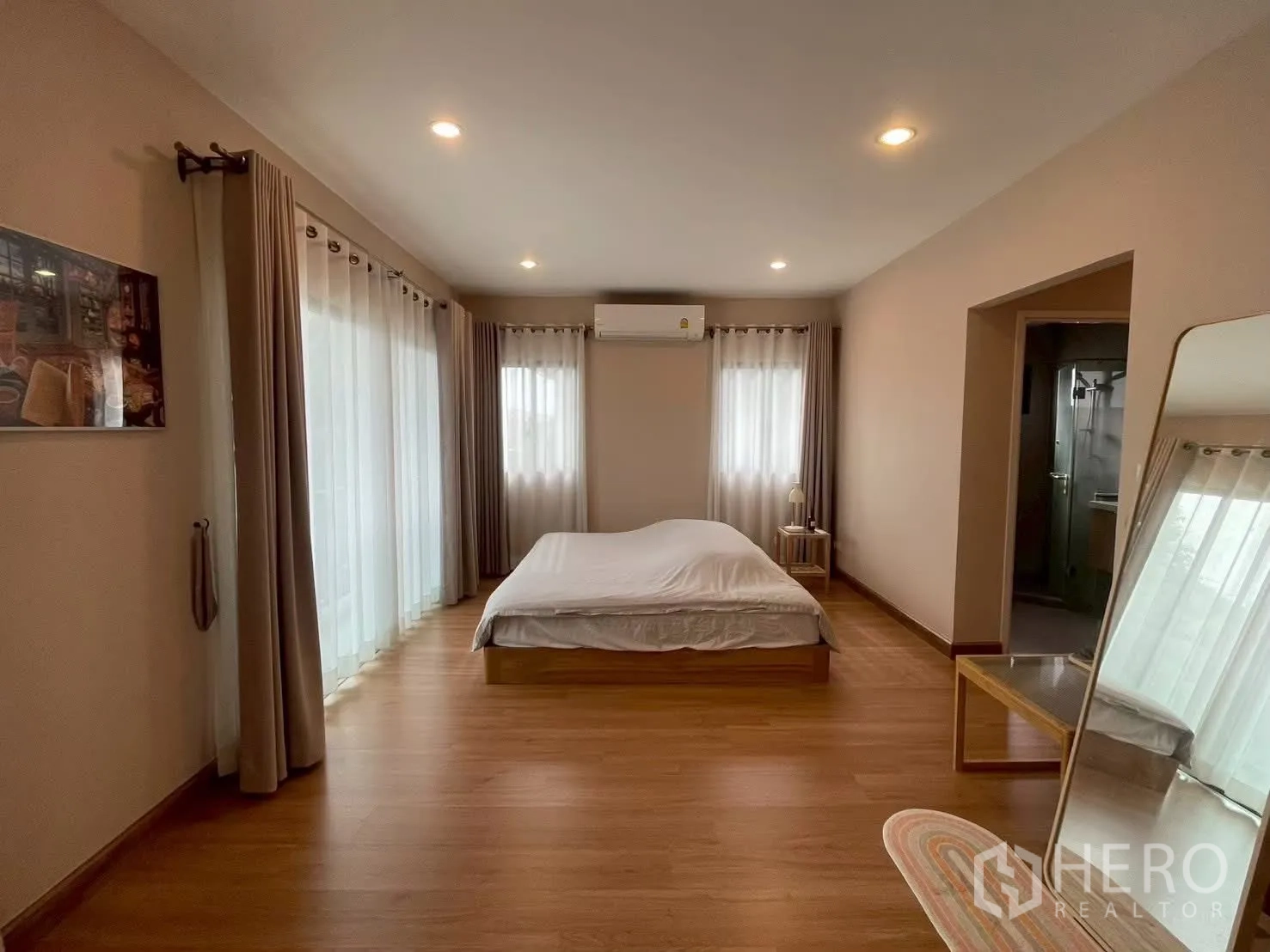 Detached House for rent in Bang Phli, Samut Prakan - Master bedroom with recessed lights, bed and dual curtained windows.