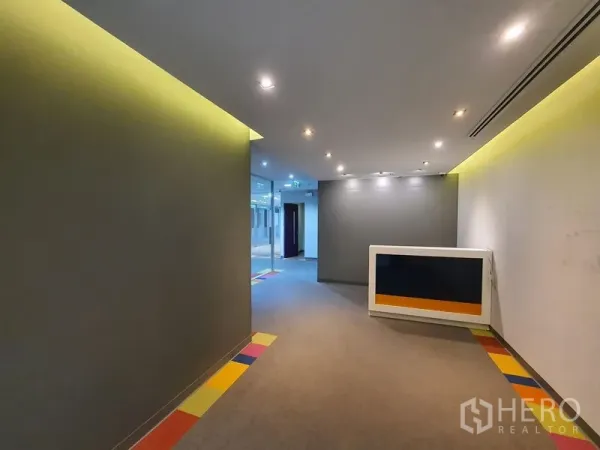Office Space for rent in Watthana, Bangkok - Reception corridor with recessed lighting and a compact front desk.