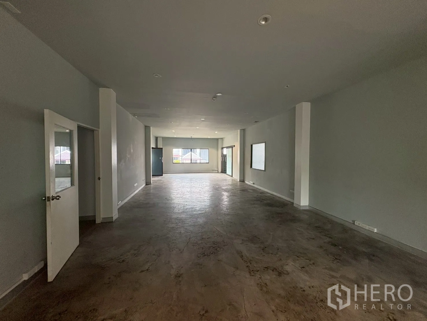 คลังสินค้า for rent in Phra Khanong, Bangkok - ชั้นสำนักงานแบบโอเพนสเปซกว้าง พื้นปูนขัดมันและไฟดาวน์ไลท์.