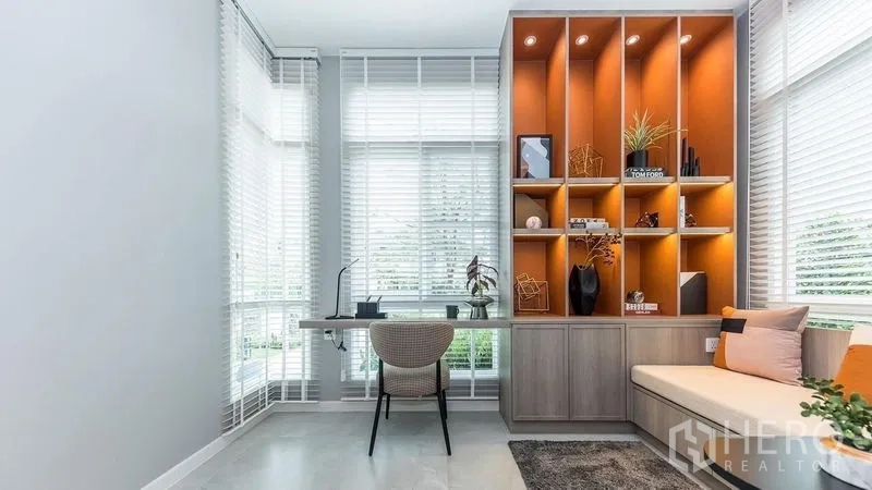 Detached House for rent in Prawet, Bangkok - Light-filled home office with built-in orange shelving, long desk and garden outlook.