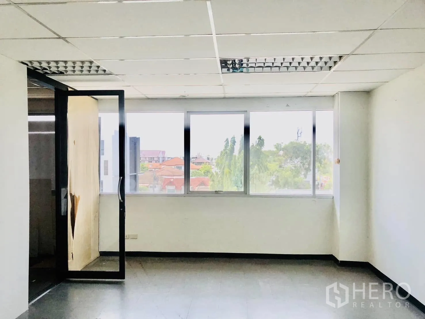Office Space for rent in Lat Phrao, Bangkok - Spacious room with wide windows and ceiling light panels.