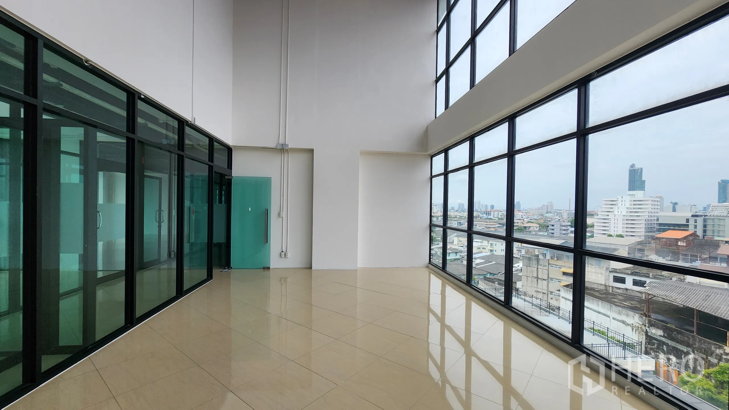 Office Space for rent in Yan Nawa, Bangkok - Glass-lined corridor with city views and teal door to office suite.