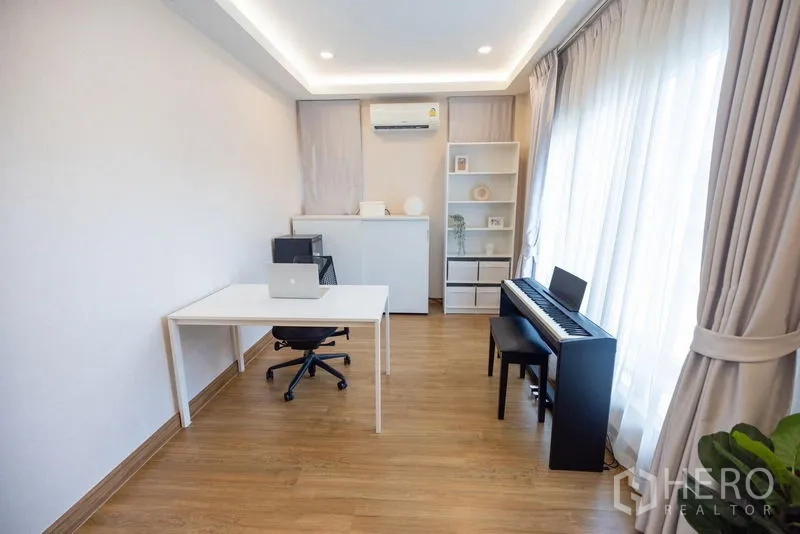 Detached House for sale in Prawet, Bangkok - Home office and music room with desk, shelving and digital piano by the window.