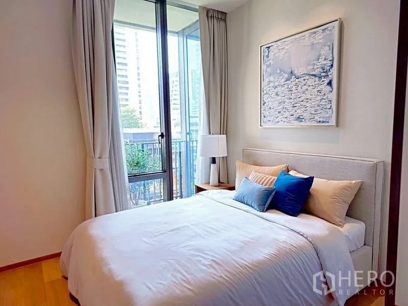 Condominium for rent or sale in Pathum Wan, Bangkok - Second bedroom with balcony door, city view, and soft neutral decor.
