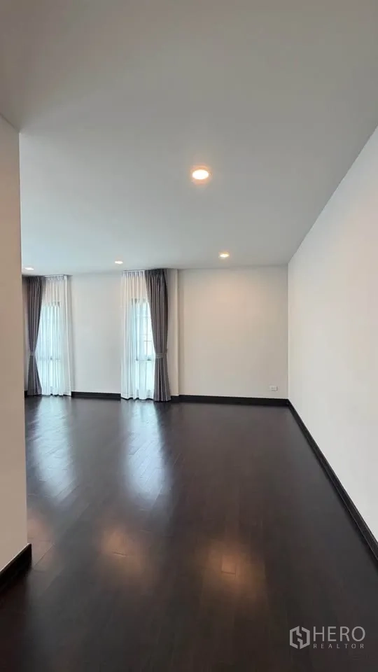 Detached House for rent in Bang Phli, Samut Prakan - Open space leading to rooms with recessed lights and dark floors.