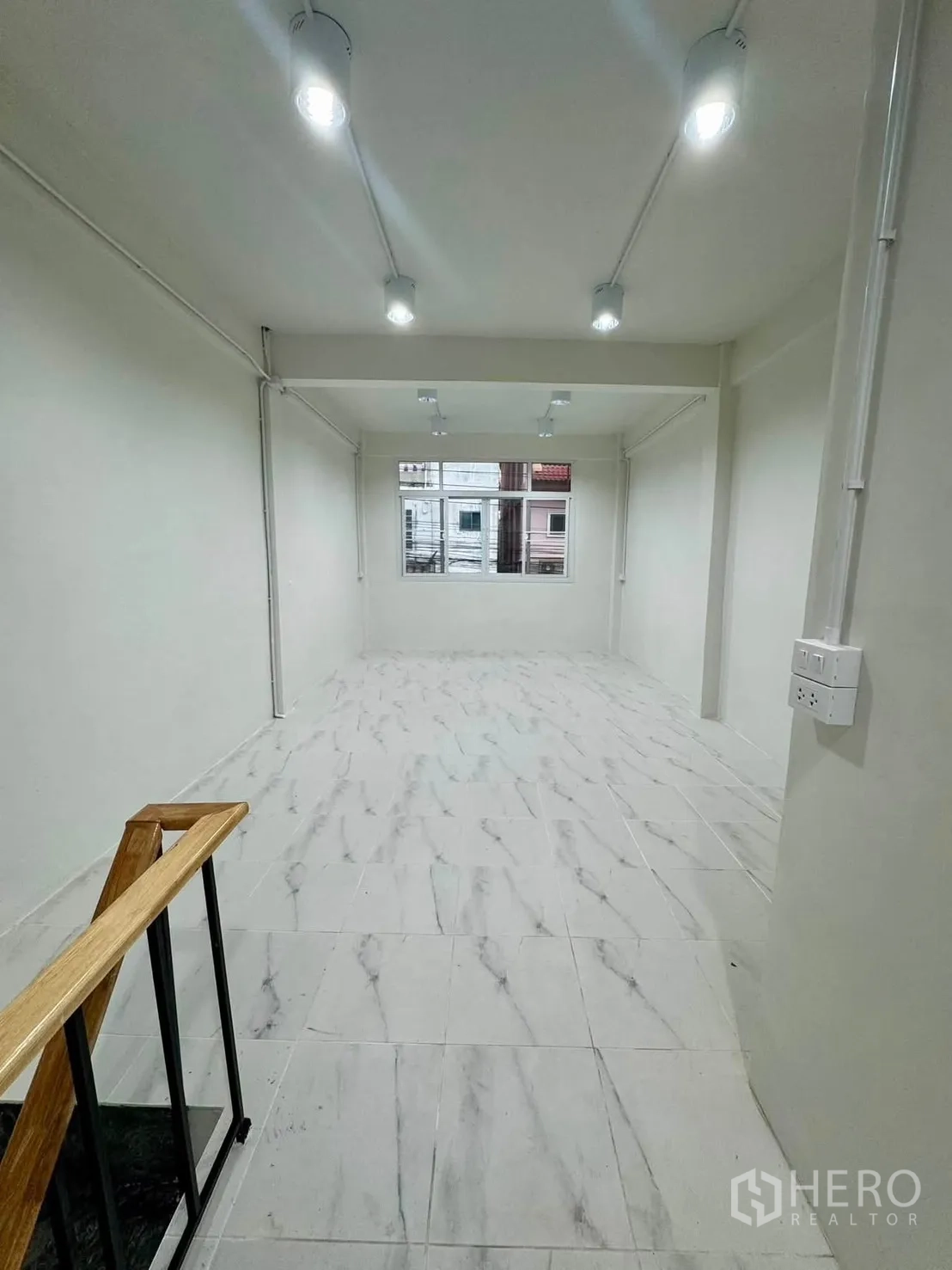 Shophouse for rent in Sathon, Bangkok - Upper-level room with window and clean white finishes.