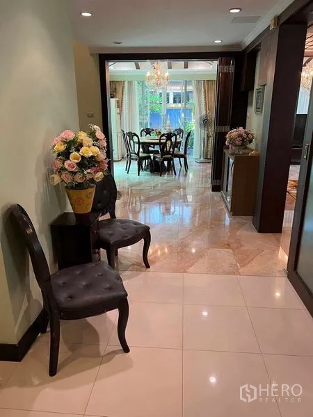 Detached House for sale in Bueng Kum, Bangkok - Hallway with polished floors leading to a bright dining room and large windows.