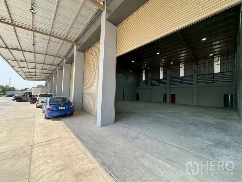 货栈 出租在Bang Phli, Samut Prakan - 带顶装卸区，多个卷帘门与宽阔车道的邦普里仓库外观