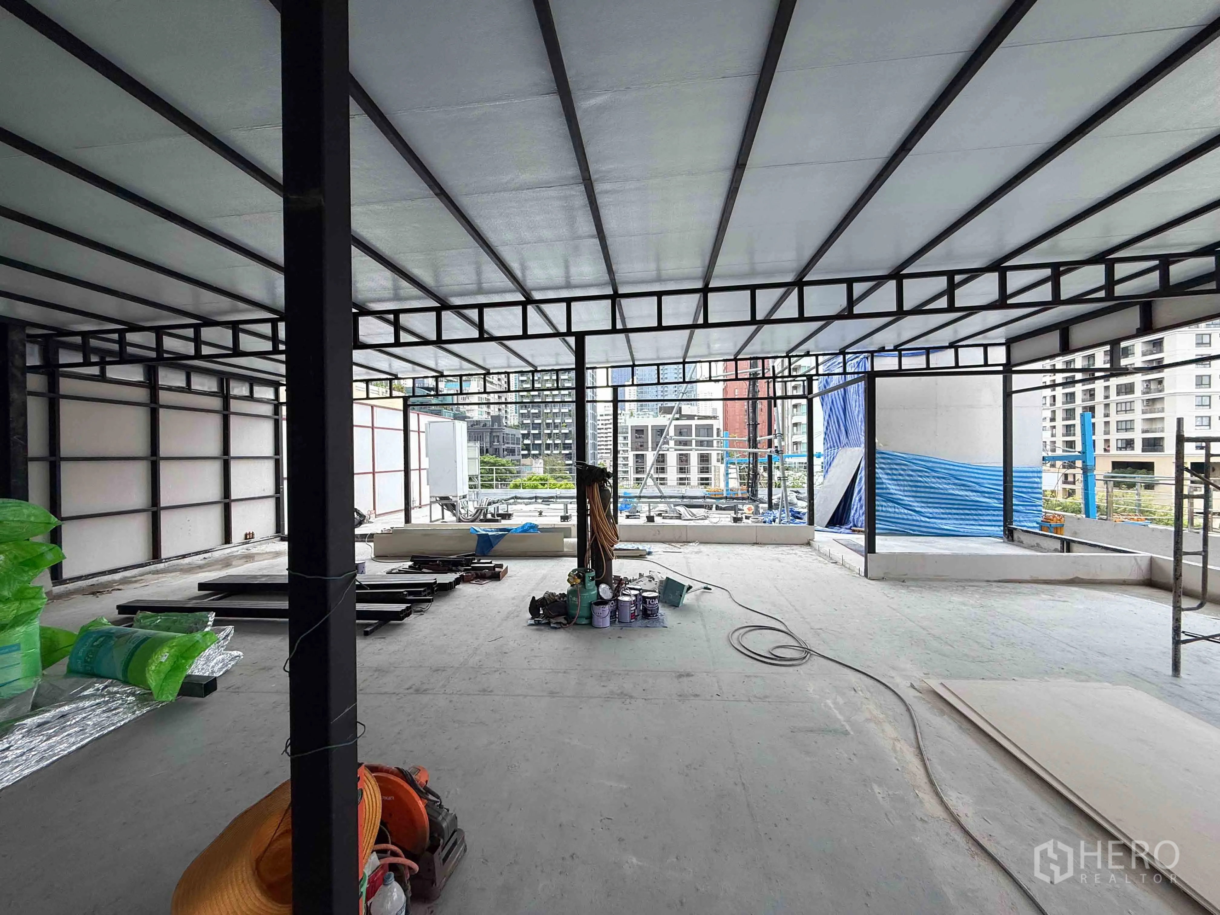 Retail Space for rent in Watthana, Bangkok - Partially built upper floor with roof cover and urban views.