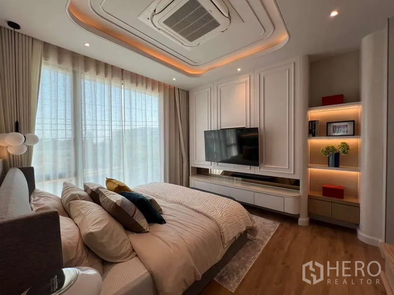 Detached House for sale in Saphan Sung, Bangkok - Master bedroom TV feature wall with built-in shelves, cove lighting and big windows.