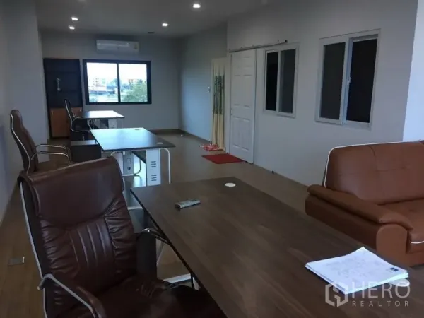 Home Office for rent or sale in Prawet, Bangkok - Open-plan office floor featuring desks, executive chairs, windows, and recessed ceiling lights.