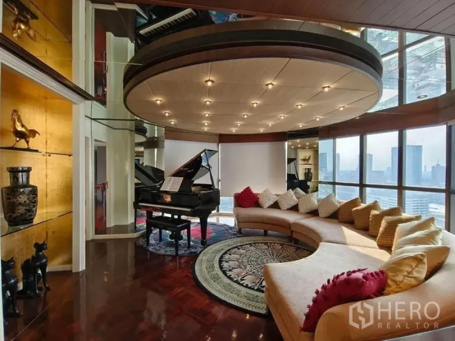 Condominium for rent in Bang Rak, Bangkok - Daytime living room showcasing a curved sofa, piano, circular ceiling, and skyline views.