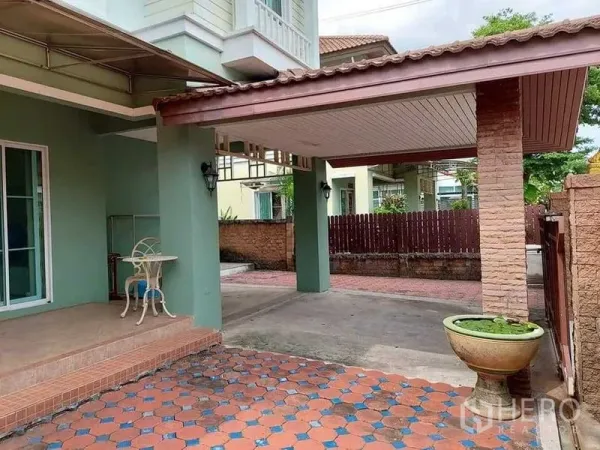Detached House for sale in Bueng Kum, Bangkok - Covered carport and front porch of a two-storey home with patterned tile walkway.