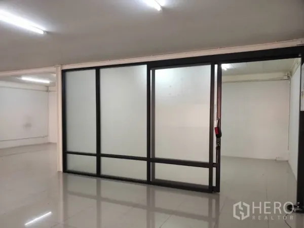 Home Office for rent in Pathum Thani - Bright office area with frosted glass sliding partitions and glossy tiled floors.