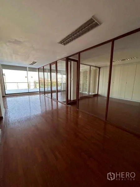 Home Office for rent or sale in Bang Phli, Samut Prakan - Sunlit office zone with glass partitions and access to a balcony at the end.