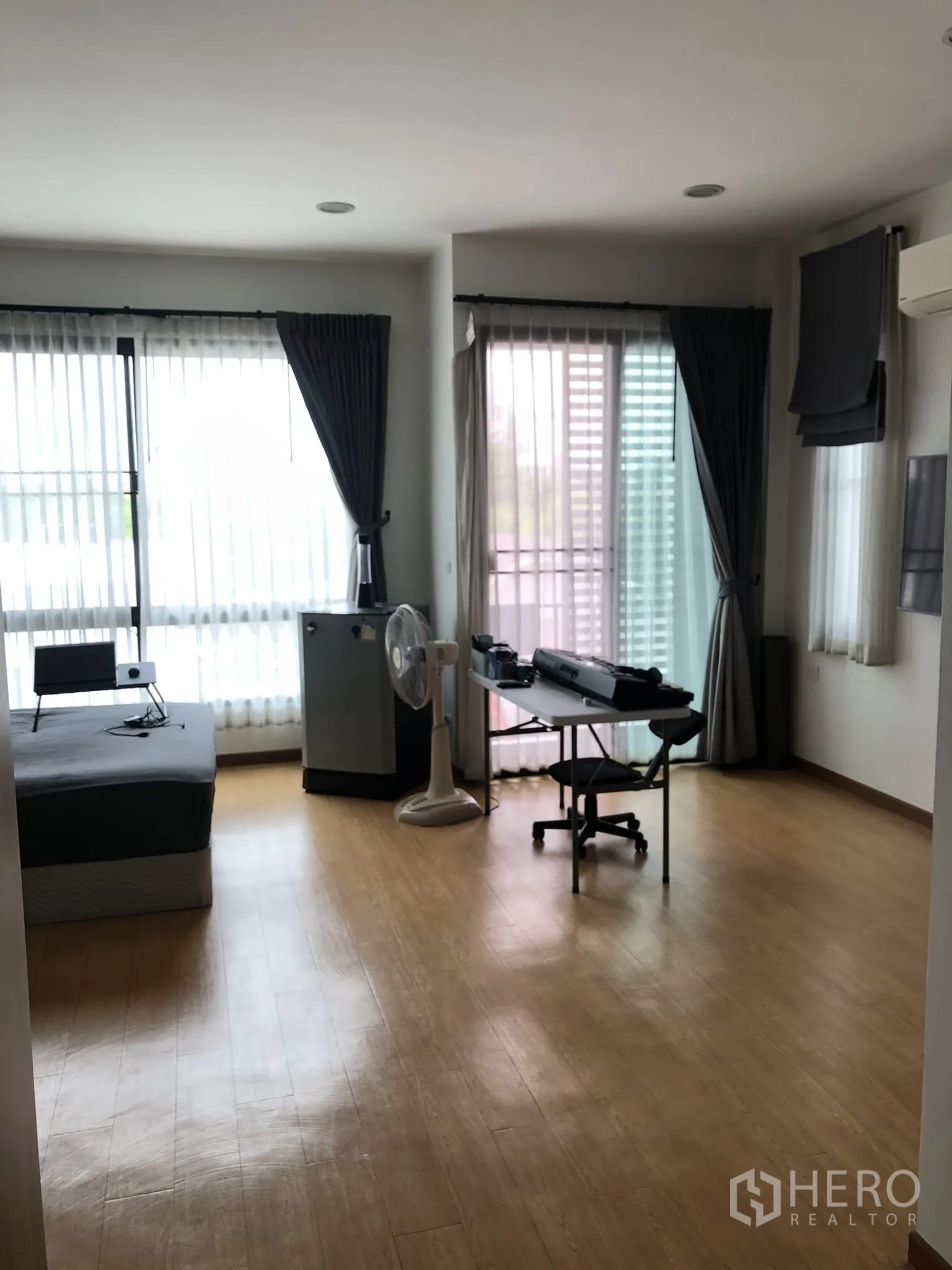 ทาวน์เฮาส์ ขายในPhra Khanong, Bangkok - ห้องมุมชั้นบนพื้นไม้ ใช้เป็นห้องนอนหรือโฮมออฟฟิศ มีหน้าต่างสูงจรดเพดานและทางออกระเบียง