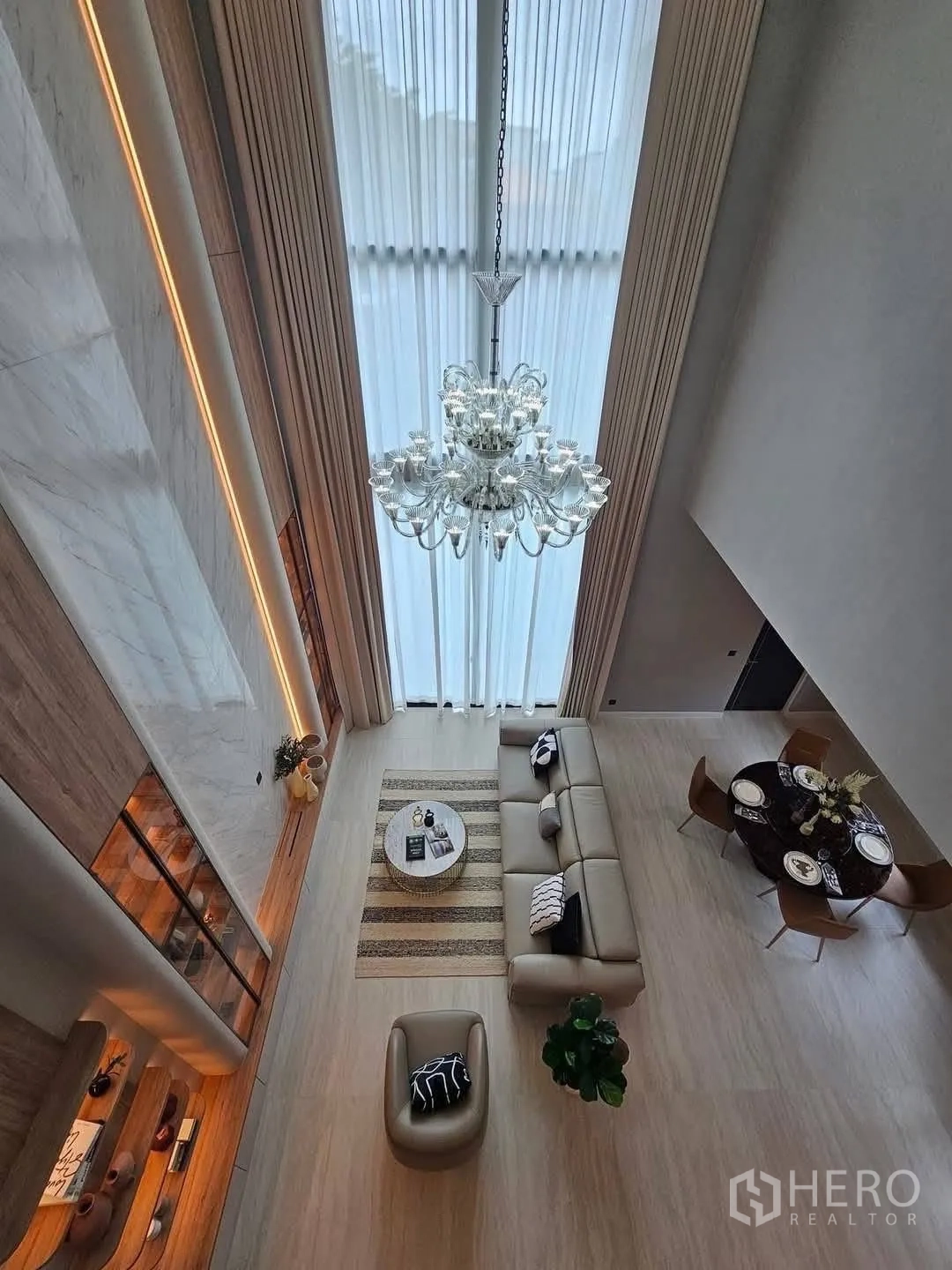 Detached House for rent or sale in Suan Luang, Bangkok - Top view of the living room showing chandelier, sofa and dining area.