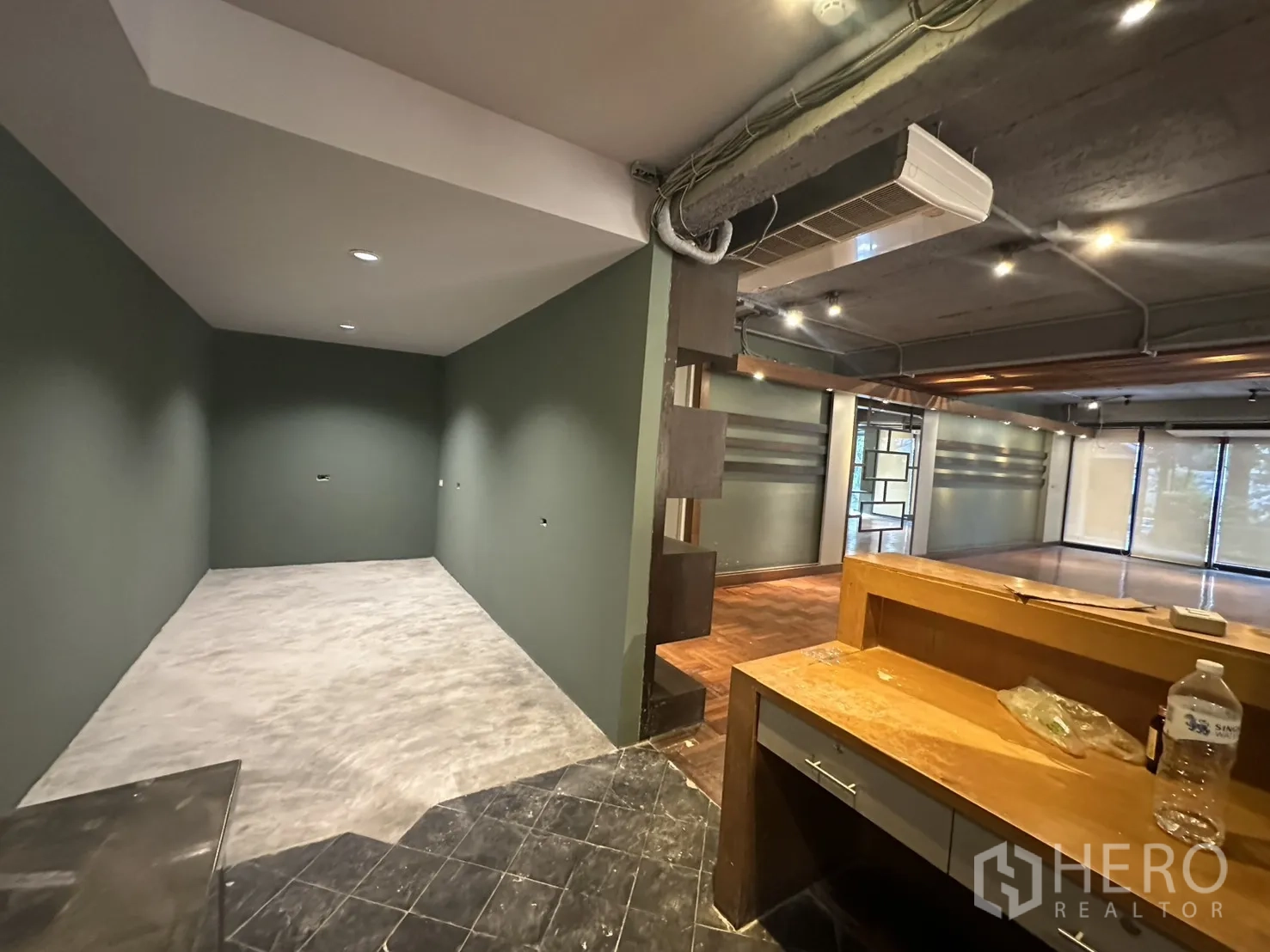 Retail Space for rent in Watthana, Bangkok - Reception or work area with built‑in desk, partial wall, and view into the main open space.