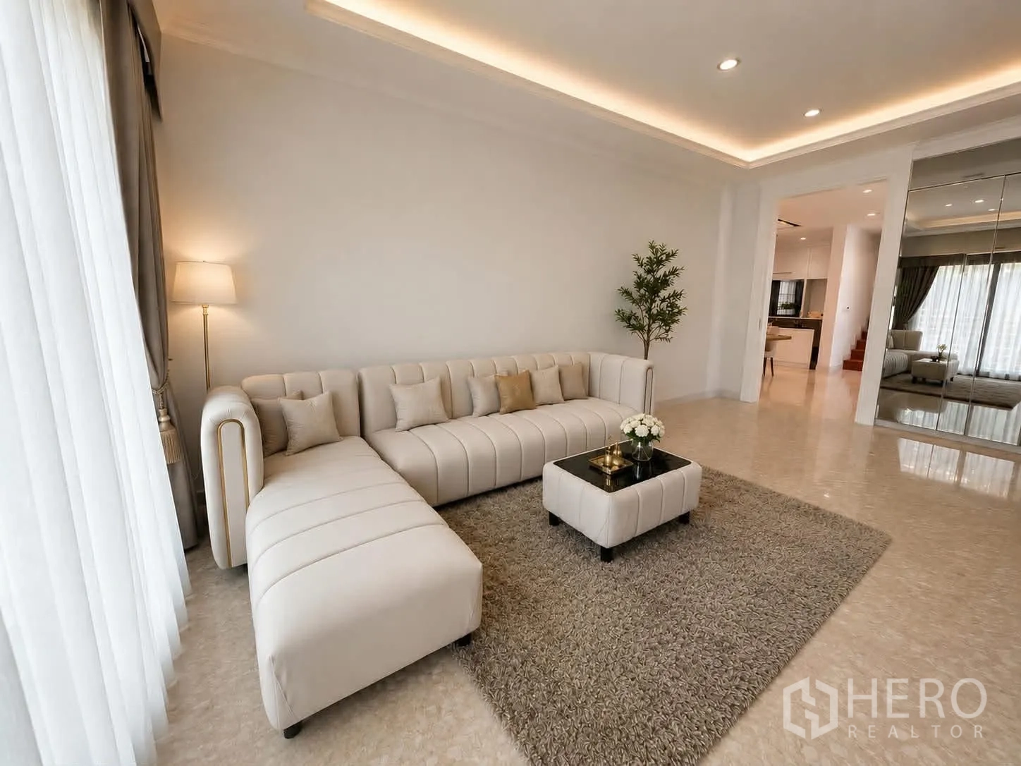 Detached House for rent or sale in Saphan Sung, Bangkok - Another angle of the living room showing sofa, mirror wall and rug.