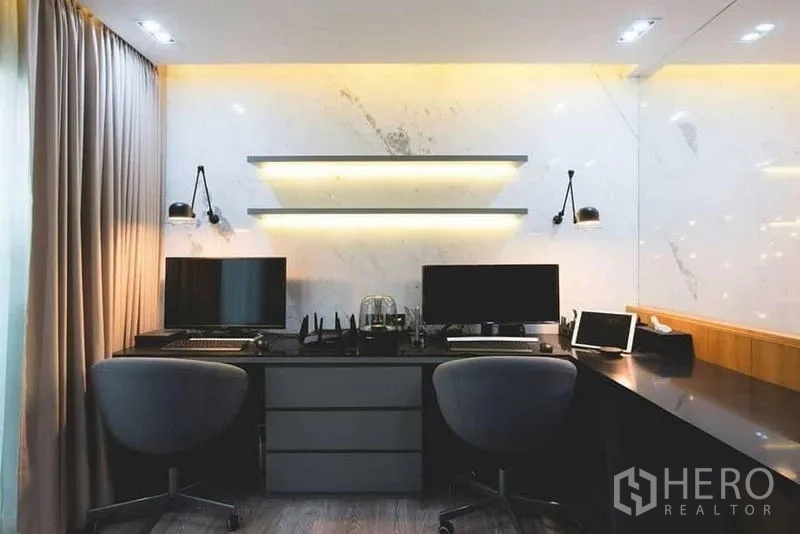 Townhouse for sale in Lak Si, Bangkok - Dual-station workspace with marble wall, floating shelves, and task lighting.